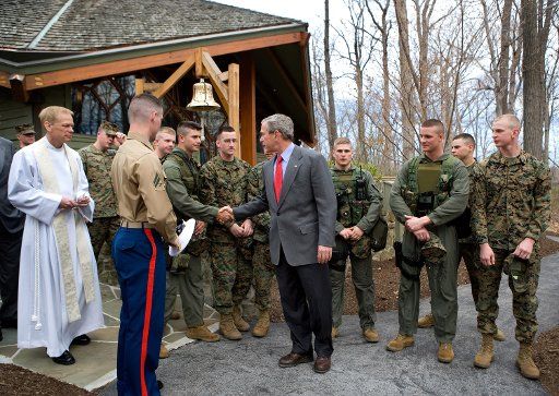 President George W. Bush visits with military personnel after attending a church service at Evergreen Chapel at Camp David Maryland Sunday April 16 2006.  (UPI Photo\/Eric Draper\/White House)