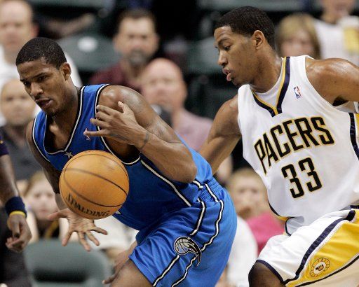 Orlando Magic forward Trevor Aziza (1) tries to grab a loose ball in front of Indianapolis Pacer Danny Granger (33) in the first half at Conseco Fieldhouse in Indianapolis In April 19 2006. (UPI Photo\/Mark Cowan)