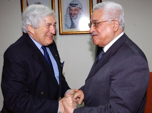 Palestinian President Mahmoud Abbas (R) meets with James Wolfensohn the international envoy to the Middle East during their meeting in the West Bank city of Ramallah March 11 2006. (UPI Photo\/Omar Rashidi\/PPO)