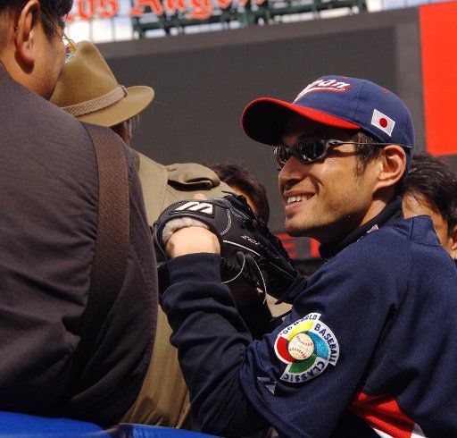 Seattle Mariners right fielder Ichiro Suzuki (R) playing for Japan in the World Baseball Classic answers questions from reporters before practice at Angel Stadium in Anaheim California on March 11 2006. Japan will face Team USA on Sunday in Round 2...