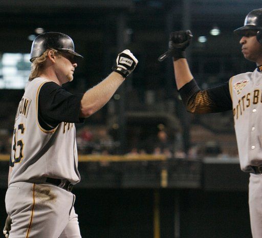 The Pittsburgh Pirates Craig Wilson is congratulated by teammate Jose Castillo after Wilson\