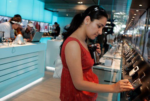 Cheenu Sandhu from Chicago looks at new Nokia cellular phones at the opening of Nokia\