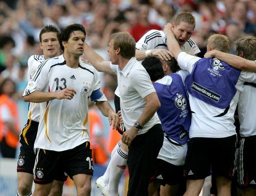Celebration after Germany defeated Sweden 2-0 in Munich Germany on June 24 2006. German coach Juergen Klinsmann congratulates Michael Ballack on the left behind Arne Friedrich.  Bastian Schweinsteiger (right) enjoys the defeat with the substitutes...