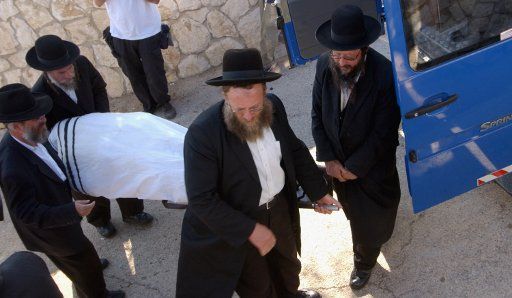 The Ultra-Orthodox burial society carry the body of Israeli settler Eliyahu Asheri 18 years at his funeral on the Mount of Olives in Jerusalem June 29 2006. The Palestinian militant groupPopular Resistance Committees said they abducted and...