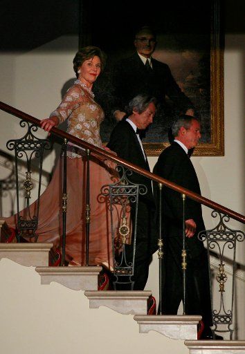 First lady Laura Bush Japan Prime Minister Junichiro Koizumi and US President George W. Bush walk down the staircase to participate in a photo opportunity in the Grand Foyer of the White House in Washington DC on June 29 2006. (UPI Photo\/Katie...