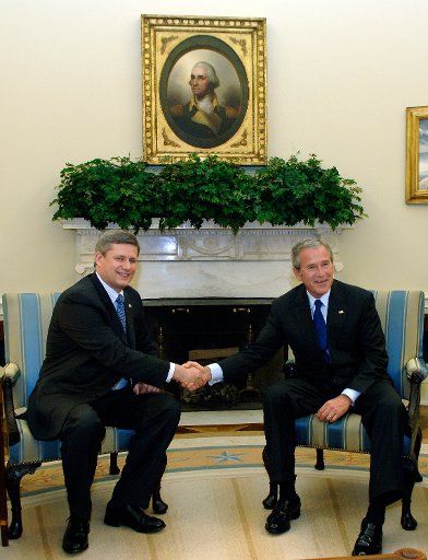 President George W. Bush (R) meets with Canadian Prime Minister Stephen Harper in the Oval Office of the White House in Washington on July 6 2006. (UPI Photo\/Kevin Dietsch)