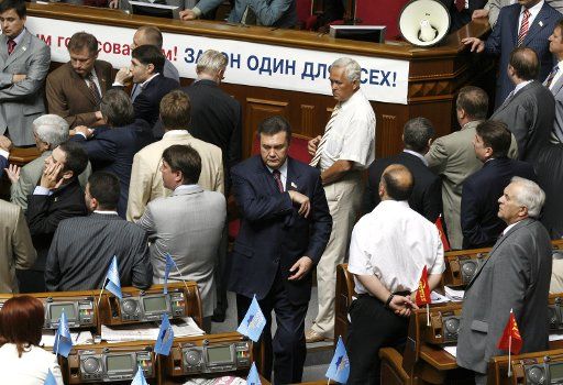 Former Ukrainian Prime minister Viktor Yanukovich (C) leader of the major opposition party leaves after the parliament session in Kiev on July 6 2006. Today his party ended a 10-day parliament blockade and lawmakers elected socialist Oleksander...