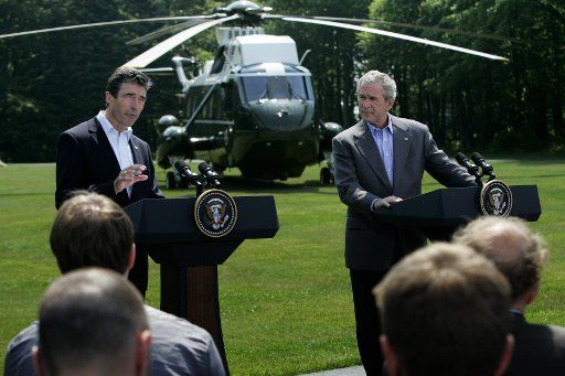 US President George W. Bush with Danish Prime Minister Anders Fogh Rasmussen responds to a question from the news media during a joint press conference at Camp David Maryland on June 9 2006. President Bush plans to mix discussions on international...