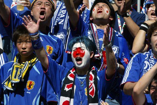  Japans colorful supporters cheer for their team in the stadium in World Cup soccer action in Kaiserslautern Germany on June 12 2006. Australia defeated Japan 3-1.  (UPI Photo\/Arthur Thill)