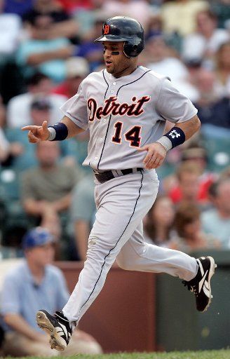 Detroit Tigers second baseman Placido Palanco (14) crosses home plate during the Tigers 9-3 victory over the Chicago Cubs at Wrigley Field in Chicago Il June 17 2006. (UPI Photo\/Mark Cowan)