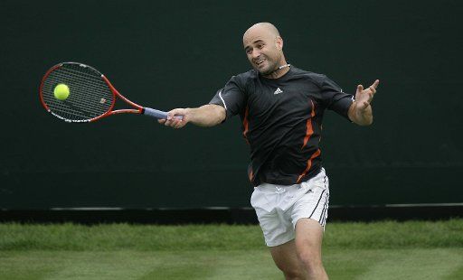 American Andre Agassi plays forehand in his match against Britain James Barker at the Boodles Challenge in Stoke Park in London on Tuesday June 20 2006. (UPI Photo\/Hugo Philpott)