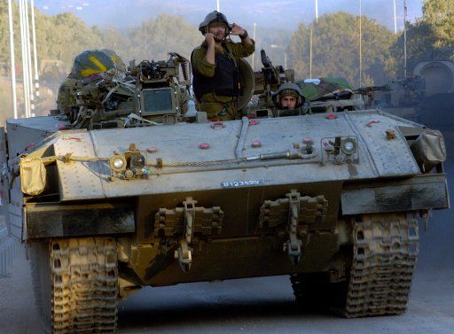 Israeli soldiers move an armoured personnel carrier on the Israeli-Lebanese border in northern Israel on July 5 2006. Twelve Israeli soldiers were killed this morning in a Hezbollah rocket attack with a direct hit on Kfar Giladi near the...