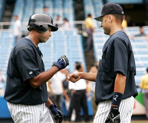 Bernie Williams left and Derek Jeter of the New York Yankees wish each other luck during batting practice before the game against the Baltimore Orioles at Yankee Stadium on August 15 2006 in New York. (UPI Photo\/Monika Graff)