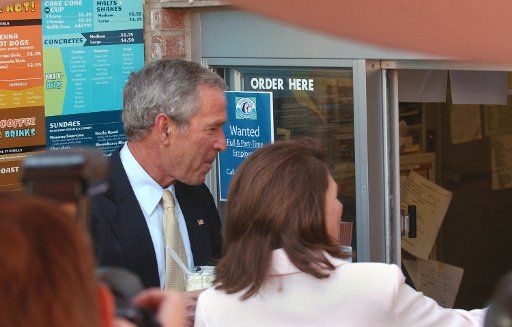 President George Bush and state Sen. Michele Bachmann (R-Stillwater)  order vanilla custard at a take-out window at Glaciers Custard and Coffee Cafe in Wayzata MN on August 22 2006 during an unscheduled stop on the way to a fundraiser for Bachmann....
