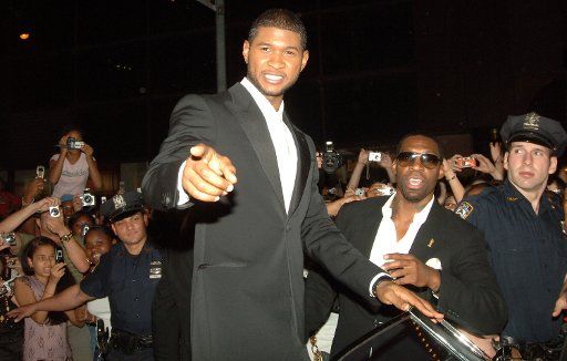 R & B singer Usher greets fans gathered outside the Ambassador theatre in New York to cheer his opening night performance and  Broadway debut in the musical "Chicago" on August 22 2006. (UPI Photo\/Ezio Petersen)