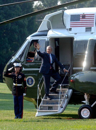 President George W. Bush waves as he makes his way to Marine One as he departs the White House in Washington on August 24 2006. The President is headed for Kennebunkport Maine. (UPI Photo\/Kevin Dietsch)