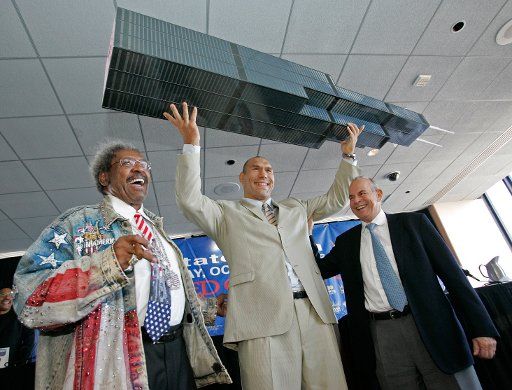 In this photo prvided by CB Richard Ellis WBA Champion Nikolai Valuev center holds a model of the Sears Tower as he stands with Don King left and Wilfried Sauerland at a news conference on August 31 2006 in Chicago Illinois. King announced an...