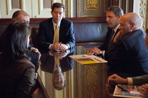 Sen. Sam Brownback (R-KS) meets with lobbyist following three Senate votes on stem cells in Washington on July 18 2006. (UPI Photo\/Kevin Dietsch)