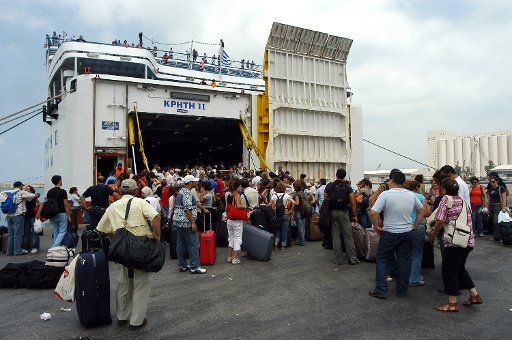 European nationals board a Greek ferry that will take them from Beirut to Cyprus on July 19 2006. Tens of thousands of foreign nationals are readying themselves for evacuation from Lebanon over the next few days. Some are leaving by bus convoys...