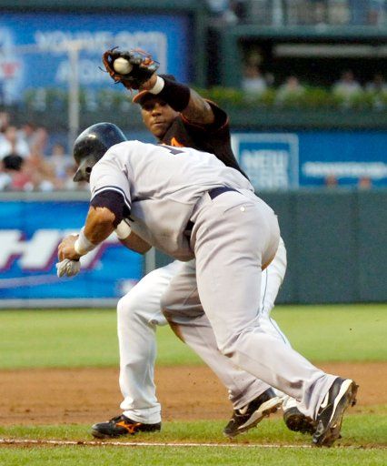 The Baltimore Orioles Melvin Mora (6) puts the tag on New York Yankees Miguel Cairo (14) who was caught in a run down in the second inning at Orioles Park at Camden Yards in Baltimore MD on August 4 2006.   (UPI Photo\/Mark Goldman)