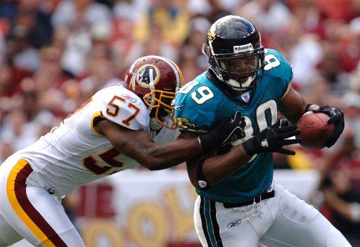 Jacksonville Jaguars Marcellus Wiley (89) completes a short second down reception against Washington Redskins Brent Hawkins (57) in the first quarter at Fed Ex Field in Landover MD on October 1 2006.  (UPI Photo\/Kevin Dietsch)