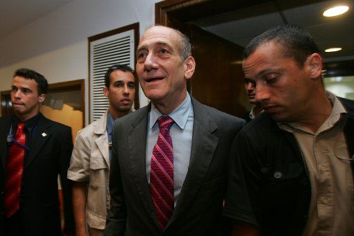 Israeli Prime Minister Ehud Olmert passes through his bodyguards as he arrives for his meeting with visiting Russian Foreign Minister Sergey Lavrov unseen September 7 2006 at Olmert\