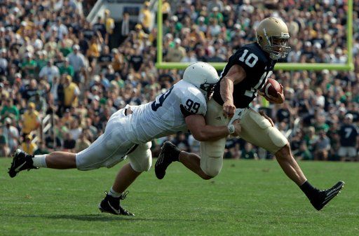 Penn State defensive end Jim Shaw (99) tackles Notre Dame quarterback Brady Quinn (10) in the first half of their game at Notre Dame stadium in South Bend IN on September 9 2006. (UPI Photo\/Mark Cowan)