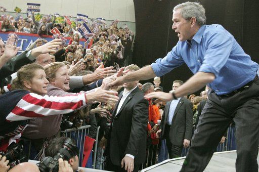President George W. Bush shakes hands with rally attendees during a stop at the Missouri Victory Rally at Missouri Southern State University in Joplin Missouri on November 3 2006. (UPI Photo\/David Stonner\/POOL)