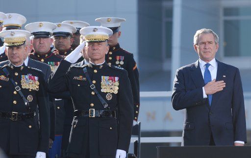 U.S. President George W. Bush (R) General Michael W. Hagee (C) and Rear Admiral Alan T. Baker (L) salute during the National Anthem at the dedication ceremony of the National Museum of the Marine Corps in Triangle Virginia on November 10 2006....
