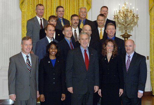 U.S. President George W. Bush poses with Astronauts from Space Shuttle Missions STS-121 and STS 115 and Space Station Missions 11 12 and 13 during a photo opportunity in the East Room of the White House on October 23 2006.    (UPI Photo\/Roger L....