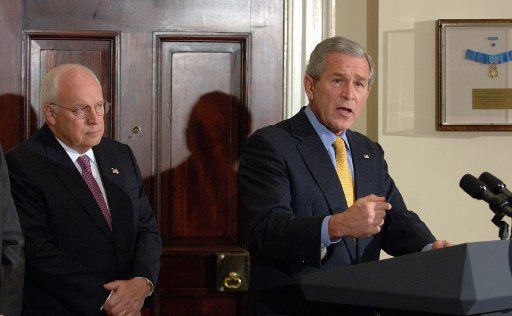 Vice President Dick Cheney listens as U.S. President George W. Bush speaks before signing the Secure Fence Act of 2006 authorizing 700 miles of fencing along the U.S.-Mexico border in the Roosevelt Room of the White House on October 26 2006.     (UPI...