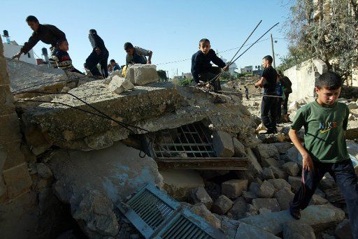 Palestinians inspect the remains of a destroyed house after it was targeted by an Israeli airstrike at Khan Yunis camp in the southern Gaza Strip October 31 2006. An Israeli warplane bombed and destroyed the house late on Monday a Palestinian...