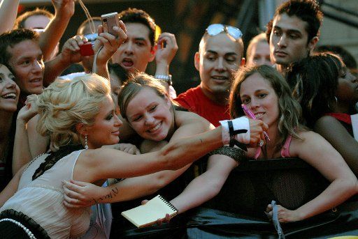 Paris Hilton signs autographs for fans at the MuchMusic Video Awards at the CHUM CityTV headquarters in Toronto Canada on June 18 2006. (UPI Photo\/Christine Chew)