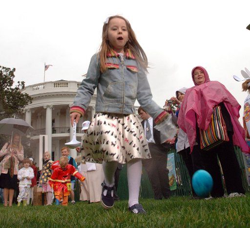 Children roll eggs on the South Lawn of the White House during the annual Easter Egg Roll on April 17 2006 in Washington.     (UPI Photo\/Roger L. Wollenberg)