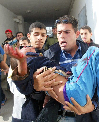 A wounded Palestinian boy is rushed in to Kamal Odwan hospital after Israeli tanks fired on homes  in Beit Hanoun in the northern Gaza Strip killing 18 13 from one family and injuring 40 on November 8 2006.  (UPI Photo\/Ismael Mohamad)
