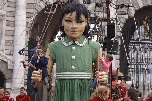 The little girl plays with children on The Mall in London on May 6 2006 as the French theatre company Royal de Luxe\