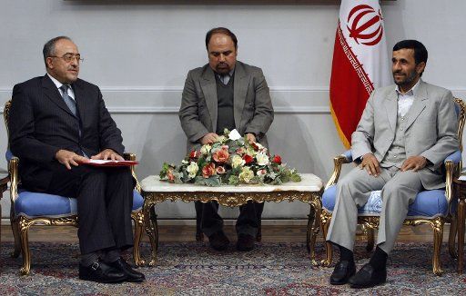 Iranian President Mahmoud Ahmadinejad (R) meets with the Tunisian ambassador Hatam Al-Sa\