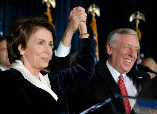 Speaker of the House Nancy Pelosi (D-CA) (L) holds hands with the House Majority Leader Steny Hoyer (D-MD) at a House Democratic leadership rally in Washington on January 5 2006. (UPI Photo\/Kevin Dietsch)