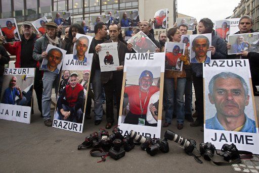 Photographers hold posters of Peruvian Agence France Presse (AFP) photojournalist Jaime Razuri during a protest to demand his release in front of the AFP headquarters in Paris January 05 2006. There was still no word on the whereabouts or state of...