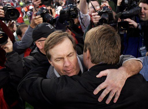 New England Patriots head coach Bill Belichick hugs New York Jets head coach Eric Mangini following the Patriots\