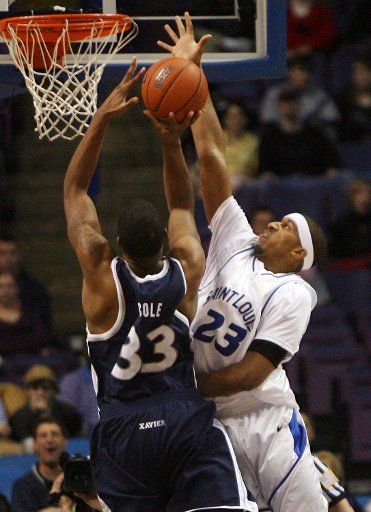 Saint Louis University Billikens Justin johnson (23) gets a hand on the basketball to reject the shot of Xavier Musketeers Brandon Cole in the first half at the Scottrade Center in St. Louis on January 13 2007. (UPI Photo\/Bill Greenblatt)