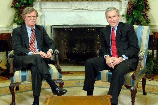 U.S. President George W. Bush (R) meets with U.S. Ambassador to the United Nations John Bolton after Bolton announced his resignation from his position in the Oval Office of the White House in Washington on December 4 2006. (UPI Photo\/Kevin Dietsch)