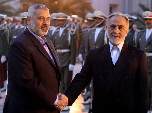 Palestinian Prime Minister Ismail Haniyeh (L) shakes hands with Iranian Vice President Parviz Davoodi during a welcoming ceremony before their meeting in Tehran on December 7 2006. (UPI Photo)