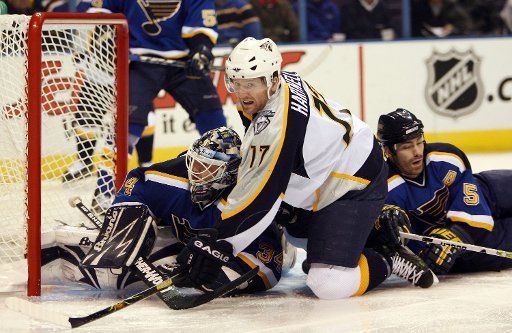 Nashville Predators Scott Hartnell (C) falls on top of St. Louis Blues goaltender Manny Legace (C) while Blues Barret Jackman (R) joins the pile after a wide shot in the first period at the Scottrade Center in St. Louis on December 17 2006.    (UPI...