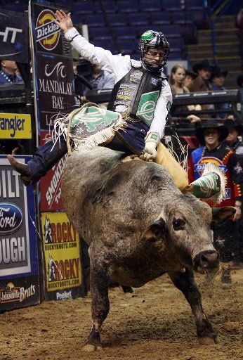 Cord McCoy of Tupelo Oklahoma rides Blue Duck the bull for eight seconds in the opening round of the Professional Bull Riders competiton at the Scottrade Center in St. Louis on February 23 2007. (UPI Photo\/Bill Greenblatt)