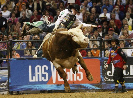 Matt Bohon of Cole Camp Missouri holds on tight to Texas the bull in the championship round of the Professional Bull Riders competition at the Scottrade Center in St. Louis on February 25 2007. Bohon won the St. Louis competition and earned $25000....