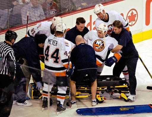 New York Islanders defenseman Radek Martinek is lifted onto a stretcher in the first period at the Bell Centre in Montreal Canada on February 3 2007. (UPI Photo\/Ed Wolfstein)