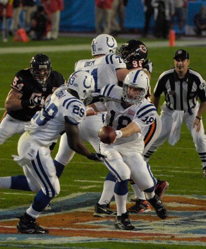 Indianapolis Colts quarterback Peyton Manning (18) hands the ball off to running back Joseph Addai (29) against the Chicago Bears at a rain soaked Super Bowl XLI at Dolphin Stadium in Miami on February 4 2007.   (UPI Photo\/Joe Marino-Bill Cantrell)