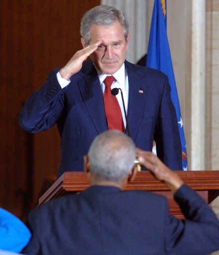 U.S. President George W. Bush salutes the Tuskegee Airmen during a ceremony to award the group a Congressional Gold Medal in the Rotunda of the U.S. Capitol in Washington on March 29 2007. Often the Tuskegee Airmen were not saluted while serving in...