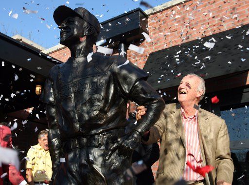 As the confetti flies former St. Louis Cardinals slugger and National Baseball Hall of Fame member Stan Musial gets a closer look at a new statue of himself after unveiling it at a new sports bar in Ladue Missouri on April 2 2007. (UPI Photo\/Bill...